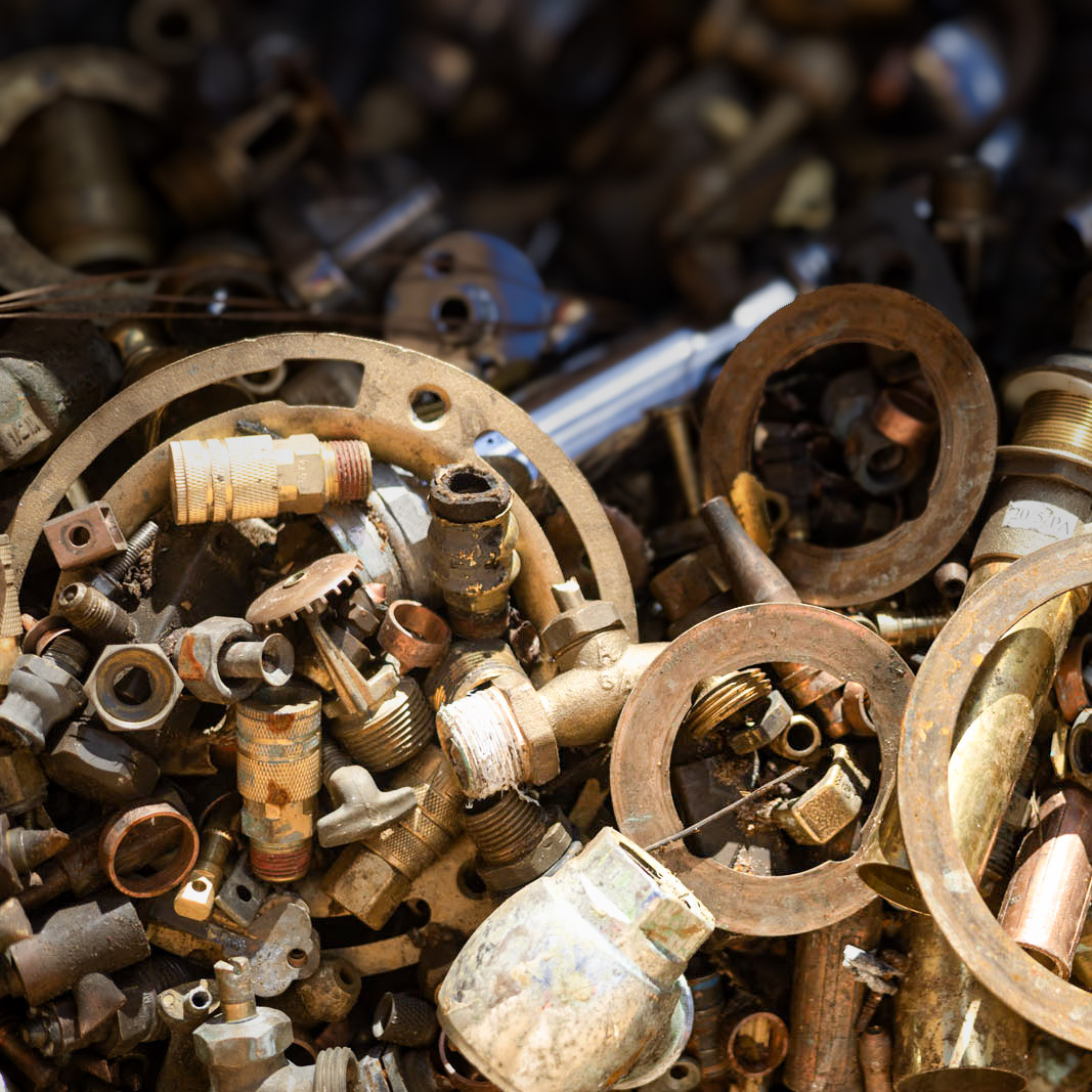 Brass valves and fittings in a bin