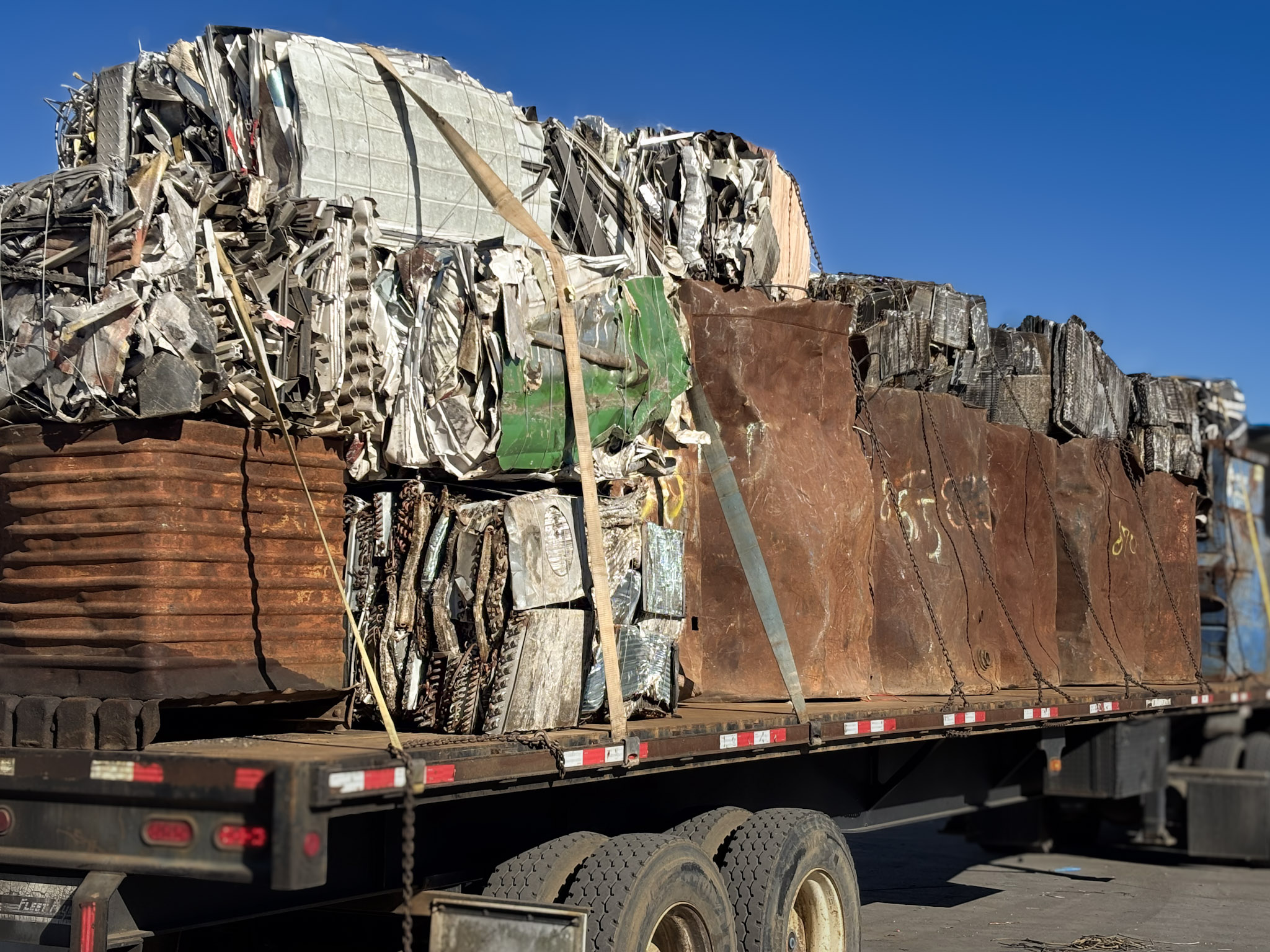 Scrap being loaded onto a flatbed truck